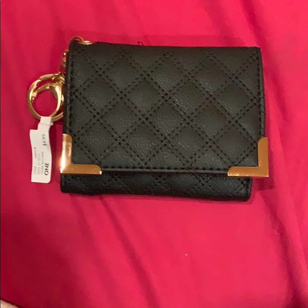 Small black wallet with gold accents